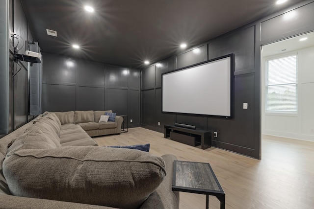 9409 Clovercroft Rd, Franklin, TN 37067 - cinema room featuring a decorative wall, light wood-style floors, and recessed lighting
