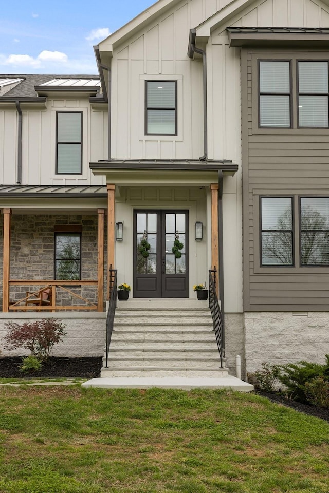 9409 Clovercroft Rd, Franklin, TN 37067 - view of exterior entry featuring board and batten siding, a porch, a standing seam roof, and french doors