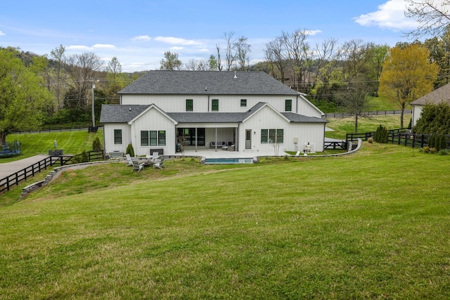 9409 Clovercroft Rd, Franklin, TN 37067 - rear view of house with a shingled roof, a patio area, and an outdoor fire pit