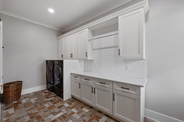 9409 Clovercroft Rd, Franklin, TN 37067 - laundry room with washing machine and dryer, cabinet space, brick flooring, ornamental molding, and recessed lighting