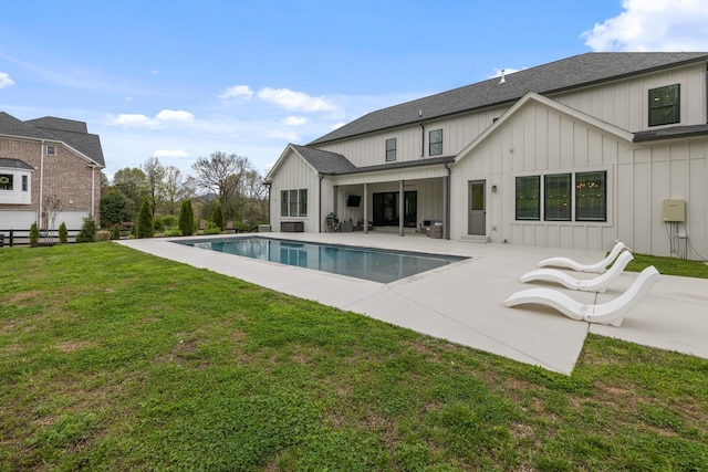 9409 Clovercroft Rd, Franklin, TN 37067 - back of property featuring a patio, a shingled roof, board and batten siding, and an outdoor pool