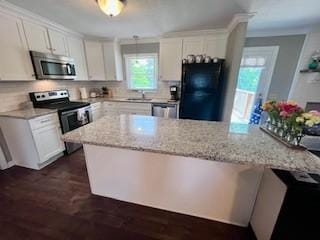1246 Imperial Dr, Columbia, TN 38401 - kitchen featuring stainless steel appliances, dark wood-type flooring, white cabinets, light stone counters, and decorative backsplash