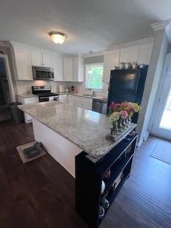 1246 Imperial Dr, Columbia, TN 38401 - kitchen featuring appliances with stainless steel finishes, plenty of natural light, white cabinets, and dark wood finished floors