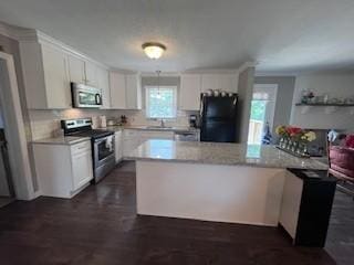 1246 Imperial Dr, Columbia, TN 38401 - kitchen with stainless steel appliances, light countertops, white cabinetry, and decorative backsplash