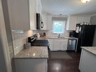 1246 Imperial Dr, Columbia, TN 38401 - kitchen with appliances with stainless steel finishes, backsplash, white cabinetry, and light stone countertops