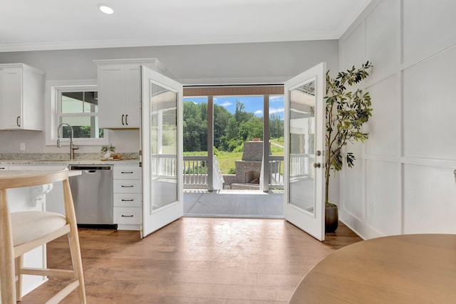 1268 S Tidwell Rd, Bon Aqua, TN 37025 - kitchen featuring stainless steel dishwasher, healthy amount of natural light, french doors, white cabinetry, and ornamental molding