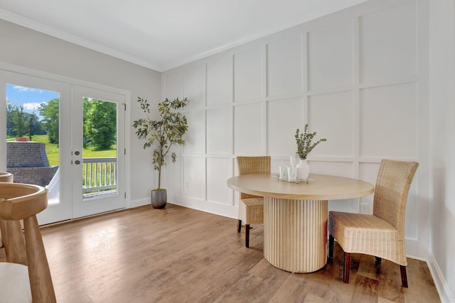 1268 S Tidwell Rd, Bon Aqua, TN 37025 - dining room featuring a decorative wall, ornamental molding, wood finished floors, and french doors