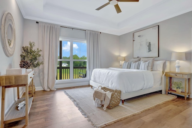1268 S Tidwell Rd, Bon Aqua, TN 37025 - bedroom featuring a raised ceiling, hardwood / wood-style flooring, ornamental molding, and ceiling fan