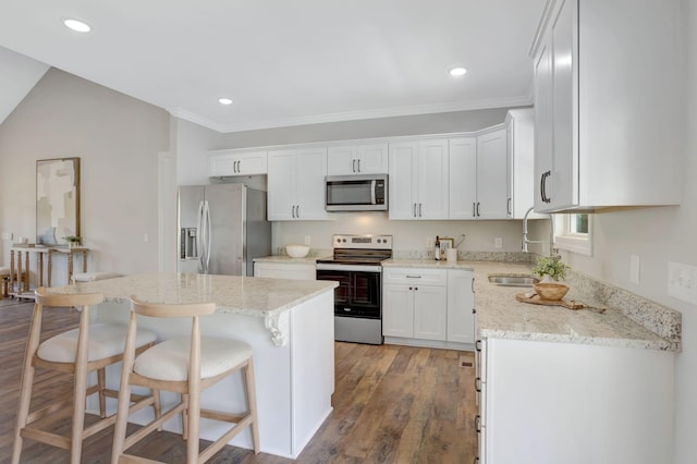 1268 S Tidwell Rd, Bon Aqua, TN 37025 - kitchen with stainless steel appliances, a kitchen breakfast bar, white cabinets, light stone countertops, and recessed lighting