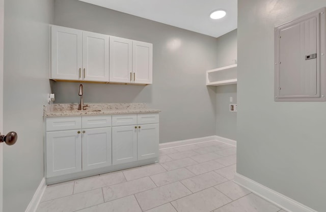 1268 S Tidwell Rd, Bon Aqua, TN 37025 - laundry area featuring electric panel, cabinet space, and washer hookup