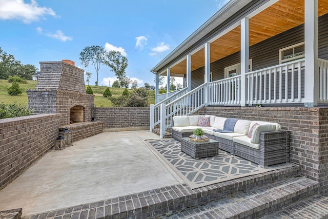 1268 S Tidwell Rd, Bon Aqua, TN 37025 - covered porch featuring an outdoor living space with a fireplace and a patio area