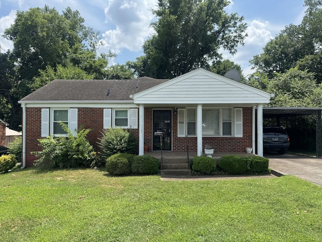 2605 Deerfield Dr, Nashville, TN 37208 - view of front of house with brick siding, covered porch, a front lawn, and concrete driveway