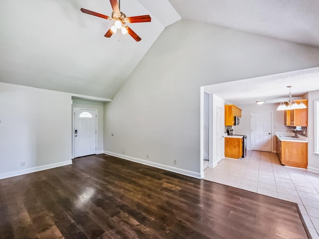 1333 Meredith Way, Clarksville, TN 37042 - unfurnished living room with light wood-style floors, ceiling fan, a chandelier, and high vaulted ceiling