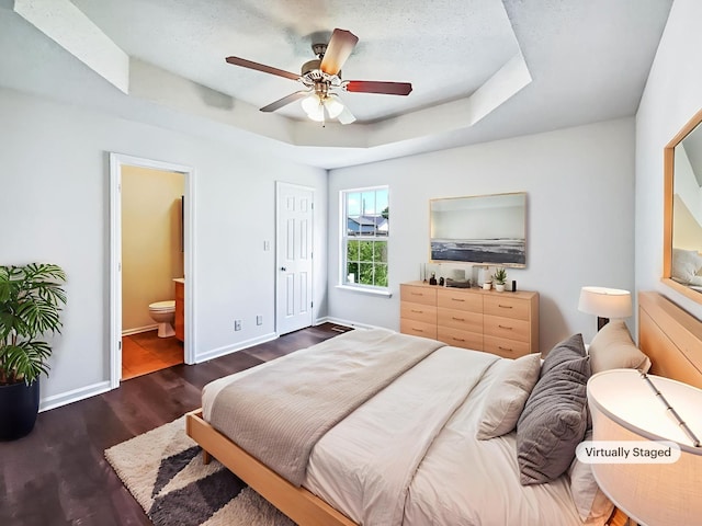 1333 Meredith Way, Clarksville, TN 37042 - bedroom featuring a raised ceiling, dark wood-style flooring, connected bathroom, and ceiling fan