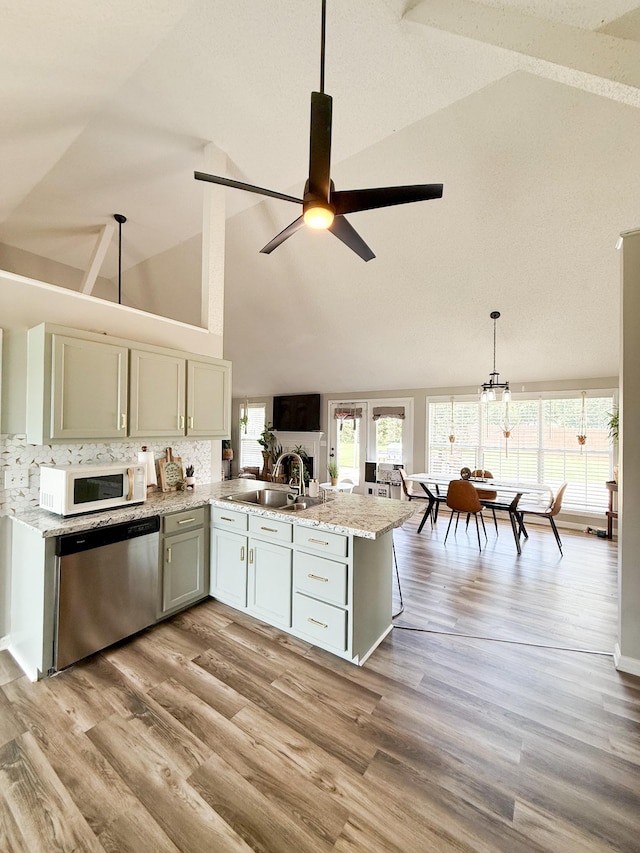 108 Easy St, Pulaski, TN 38478 - kitchen with dishwasher, white microwave, high vaulted ceiling, ceiling fan, and tasteful backsplash