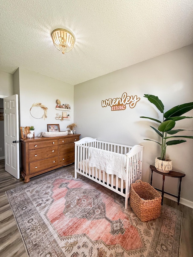 108 Easy St, Pulaski, TN 38478 - bedroom with wood finished floors, a textured ceiling, and a crib