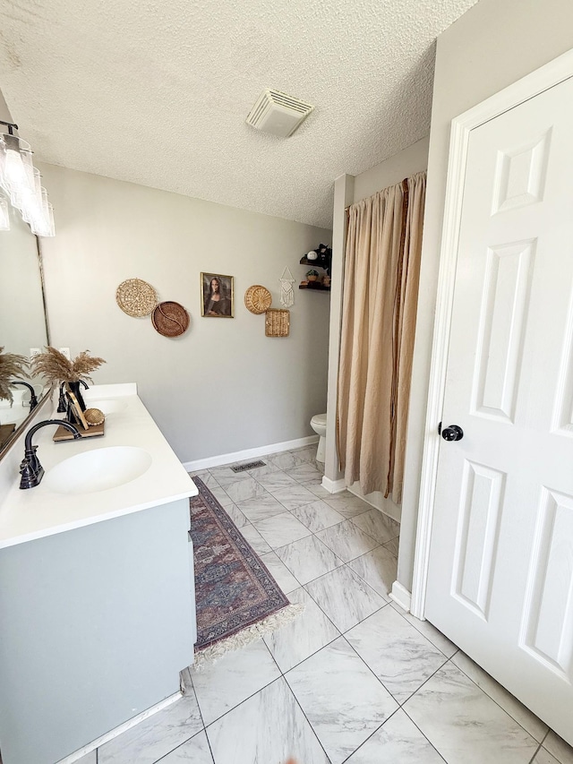 108 Easy St, Pulaski, TN 38478 - full bathroom with marble look tile flooring, double vanity, and a textured ceiling