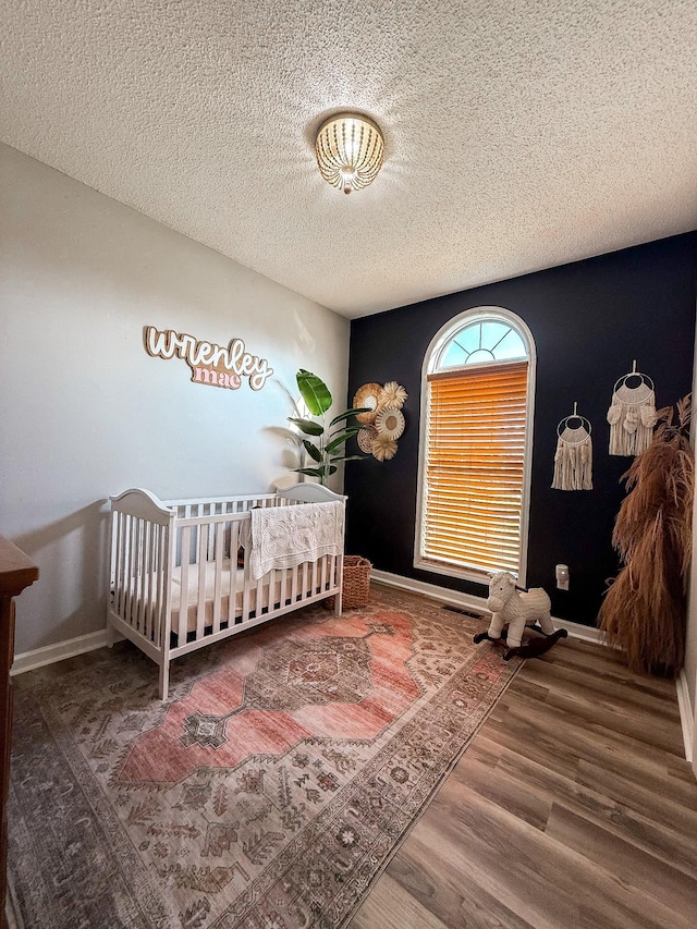 108 Easy St, Pulaski, TN 38478 - bedroom with wood finished floors, a crib, and a textured ceiling