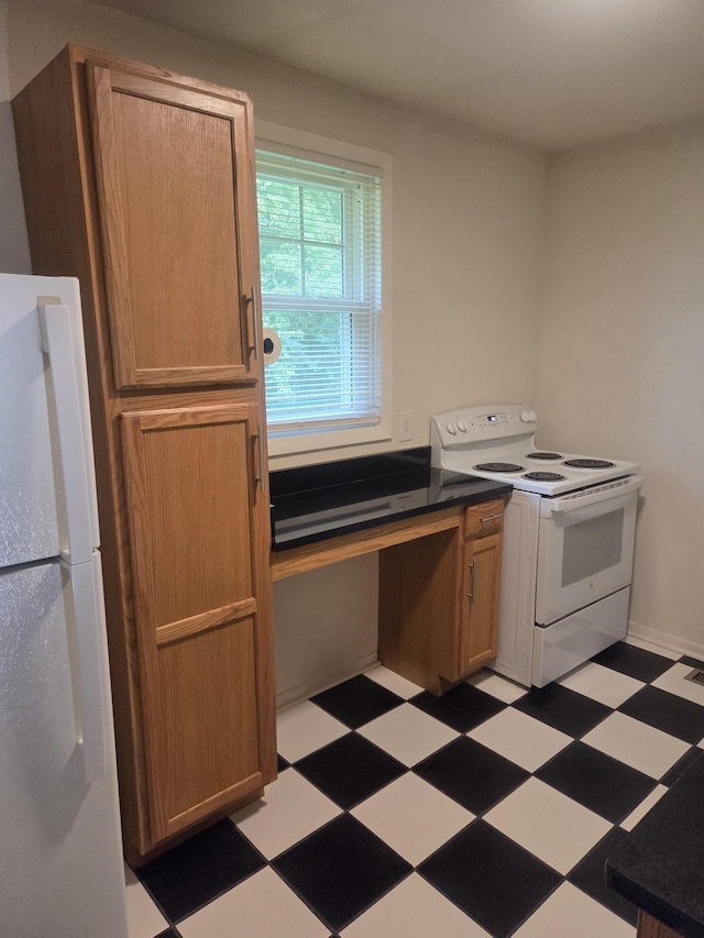 419 Kinsey Blvd, Madison, TN 37115 - kitchen featuring white appliances, tile patterned floors, and dark countertops