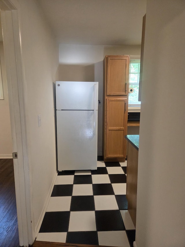 419 Kinsey Blvd, Madison, TN 37115 - kitchen with freestanding refrigerator, tile patterned floors, and brown cabinetry