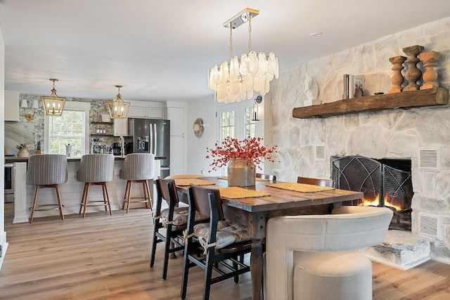 3510 Bybee Branch Rd, Mcminnville, TN 37110 - dining area featuring a chandelier, light wood-type flooring, and healthy amount of natural light