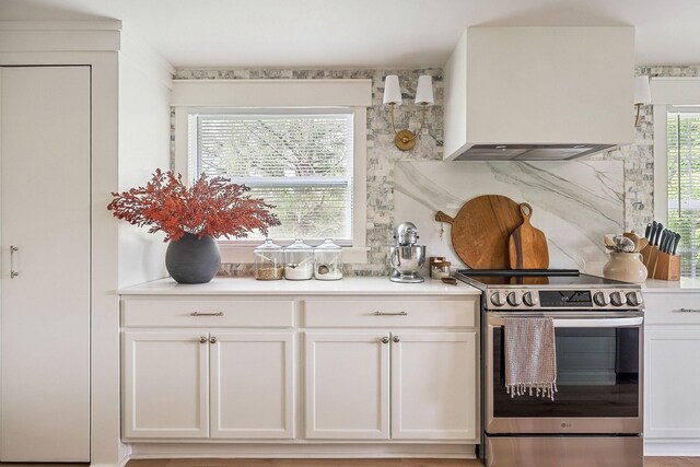 3510 Bybee Branch Rd, Mcminnville, TN 37110 - kitchen featuring electric range, custom range hood, white cabinetry, light countertops, and tasteful backsplash