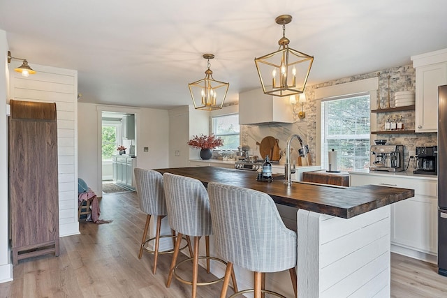 3510 Bybee Branch Rd, Mcminnville, TN 37110 - kitchen with wood counters, a chandelier, plenty of natural light, and light wood-style floors