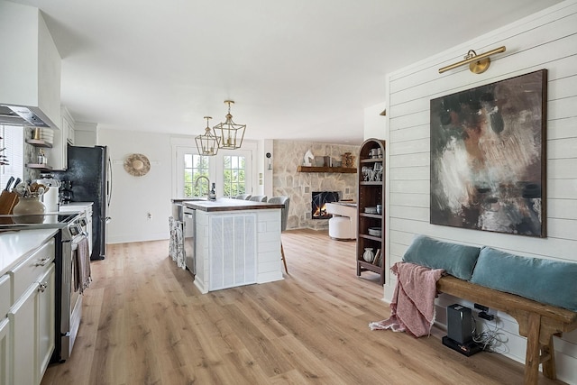 3510 Bybee Branch Rd, Mcminnville, TN 37110 - kitchen featuring appliances with stainless steel finishes, open floor plan, extractor fan, and light wood-type flooring
