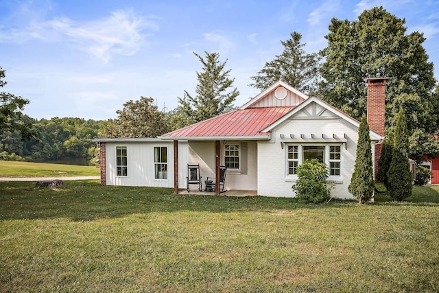 3510 Bybee Branch Rd, Mcminnville, TN 37110 - back of house featuring a yard, brick siding, a metal roof, a patio, and board and batten siding