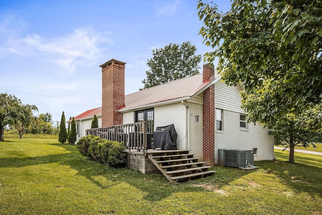 3510 Bybee Branch Rd, Mcminnville, TN 37110 - back of property featuring a chimney, brick siding, a yard, a wooden deck, and a metal roof