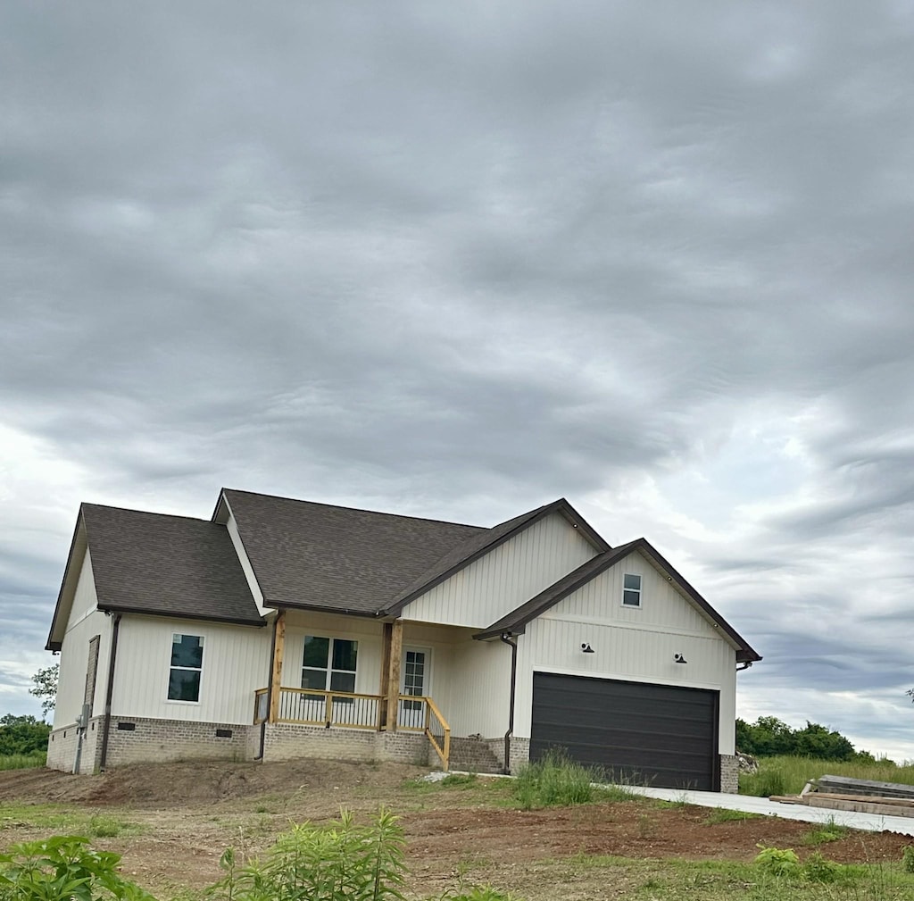 134 Lightfoot Ln, Estill Springs, TN 37330 - modern inspired farmhouse featuring covered porch, an attached garage, roof with shingles, crawl space, and driveway