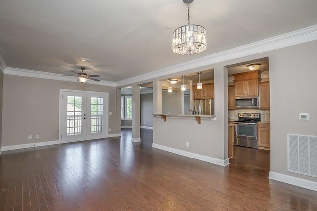 991 Westhaven Blvd Unit 32, Franklin, TN 37064 - unfurnished living room featuring crown molding, a chandelier, dark wood-type flooring, a ceiling fan, and french doors
