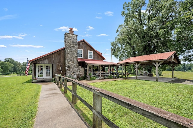 540 Powell Hollow Rd, Tullahoma, TN 37388 - rear view of property featuring french doors, a yard, a chimney, a metal roof, and a gazebo