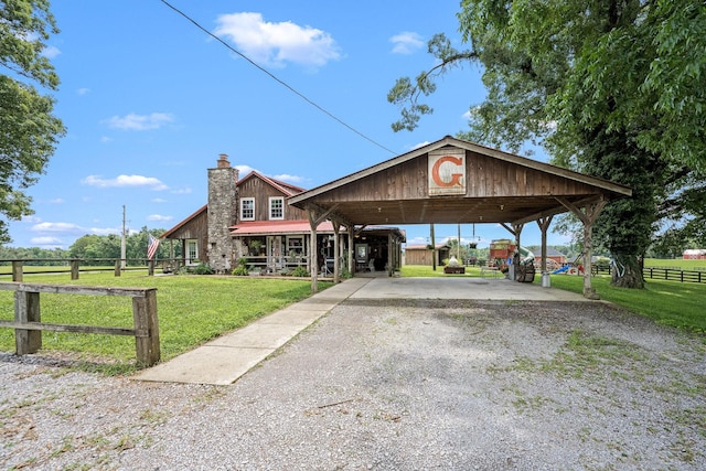 540 Powell Hollow Rd, Tullahoma, TN 37388 - view of front of property with gravel driveway, a chimney, a carport, and a metal roof