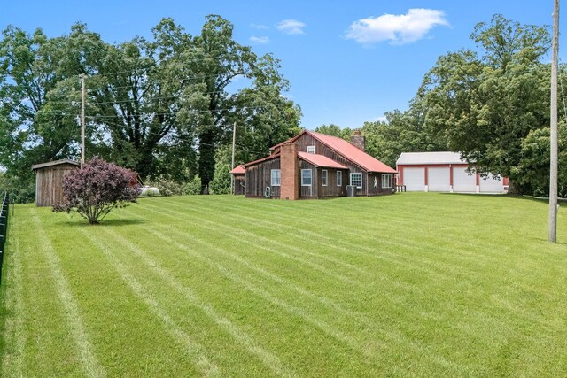 540 Powell Hollow Rd, Tullahoma, TN 37388 - view of green lawn with an outbuilding and a garage