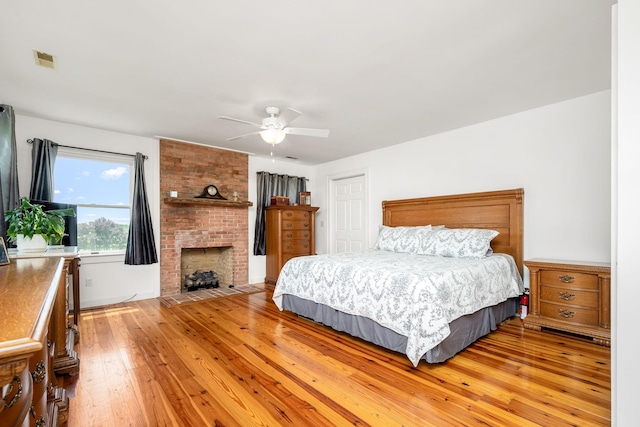 540 Powell Hollow Rd, Tullahoma, TN 37388 - bedroom with light wood finished floors, a closet, a fireplace, and a ceiling fan