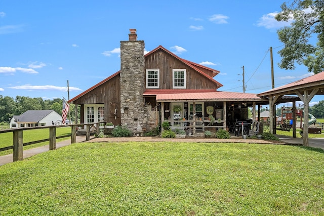540 Powell Hollow Rd, Tullahoma, TN 37388 - rear view of property featuring a lawn, a chimney, a porch, and a metal roof