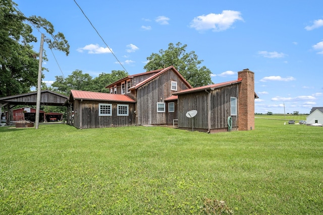 540 Powell Hollow Rd, Tullahoma, TN 37388 - back of house featuring a lawn, a metal roof, and an outdoor structure