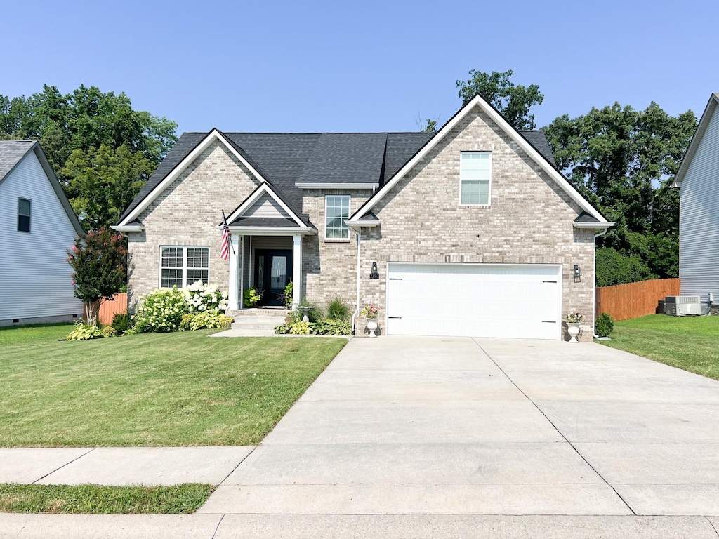 2380 Colston Dr, Clarksville, TN 37042 - traditional-style home with concrete driveway, a garage, brick siding, and roof with shingles