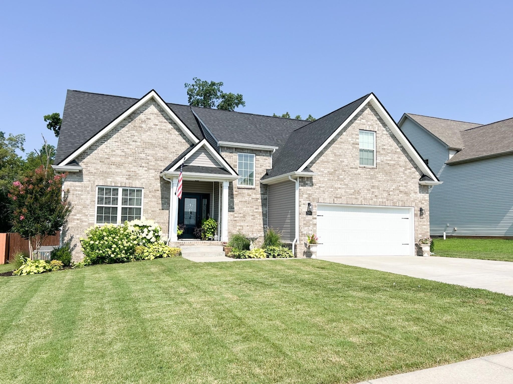 2380 Colston Dr, Clarksville, TN 37042 - view of front of home featuring brick siding, concrete driveway, a garage, and a front lawn