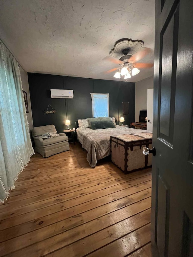2016 Tennessee St, Westpoint, TN 38486 - bedroom with wood-type flooring, a wall mounted AC, and a ceiling fan