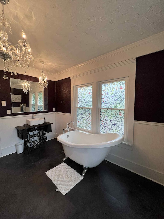 2016 Tennessee St, Westpoint, TN 38486 - full bathroom featuring a chandelier, a soaking tub, a wainscoted wall, healthy amount of natural light, and crown molding