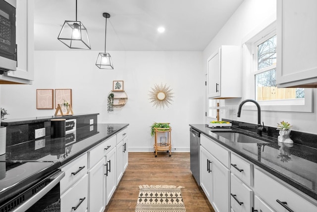 914 Power St Unit 12, Clarksville, TN 37042 - kitchen featuring white cabinetry, appliances with stainless steel finishes, wood finished floors, dark stone countertops, and recessed lighting