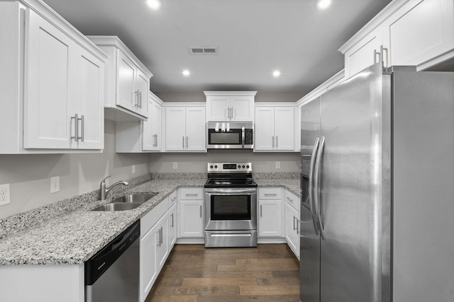 5538 Hamilton Cir, Antioch, TN 37013 - kitchen featuring stainless steel appliances, recessed lighting, white cabinets, dark wood-style flooring, and light stone countertops