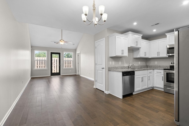 5538 Hamilton Cir, Antioch, TN 37013 - kitchen featuring appliances with stainless steel finishes, open floor plan, white cabinetry, light stone countertops, and recessed lighting