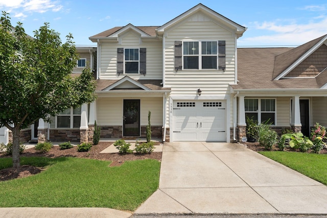 5538 Hamilton Cir, Antioch, TN 37013 - craftsman-style house with driveway, stone siding, a front yard, an attached garage, and a shingled roof