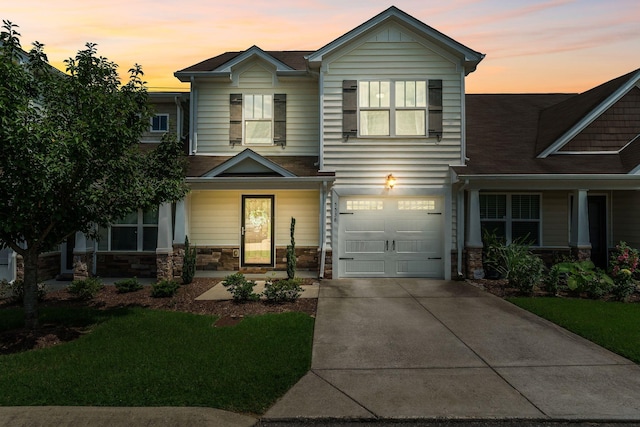 5538 Hamilton Cir, Antioch, TN 37013 - view of front facade with stone siding, an attached garage, concrete driveway, and covered porch