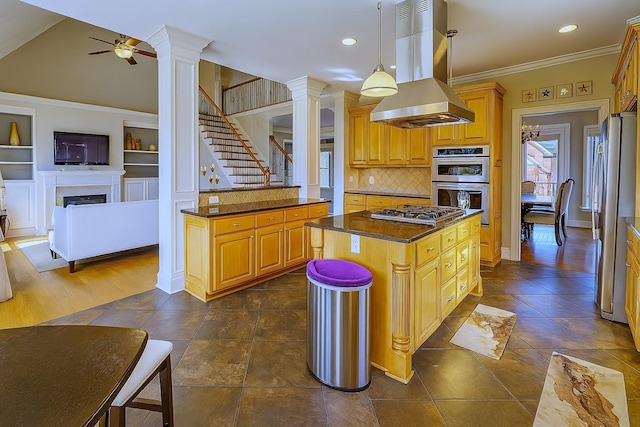 1413 Station Four Ln, Old Hickory, TN 37138 - kitchen with wall chimney range hood, appliances with stainless steel finishes, decorative columns, a ceiling fan, and tasteful backsplash
