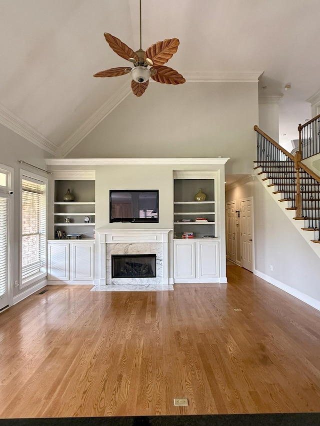 1413 Station Four Ln, Old Hickory, TN 37138 - unfurnished living room featuring built in features, high vaulted ceiling, a ceiling fan, a high end fireplace, and stairway