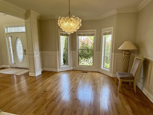 1413 Station Four Ln, Old Hickory, TN 37138 - foyer with a chandelier, wood finished floors, a decorative wall, wainscoting, and ornate columns